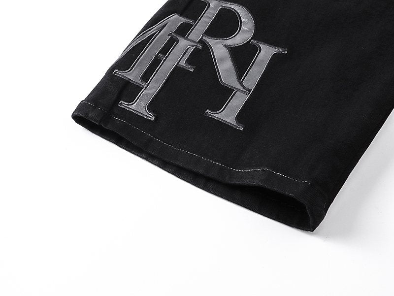 AMIRI Tonal Monogram Denim Shorts — detail
