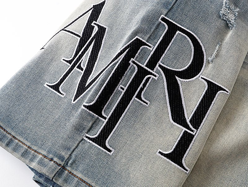 AMIRI Light Blue Distressed Monogram Denim Shorts — detail