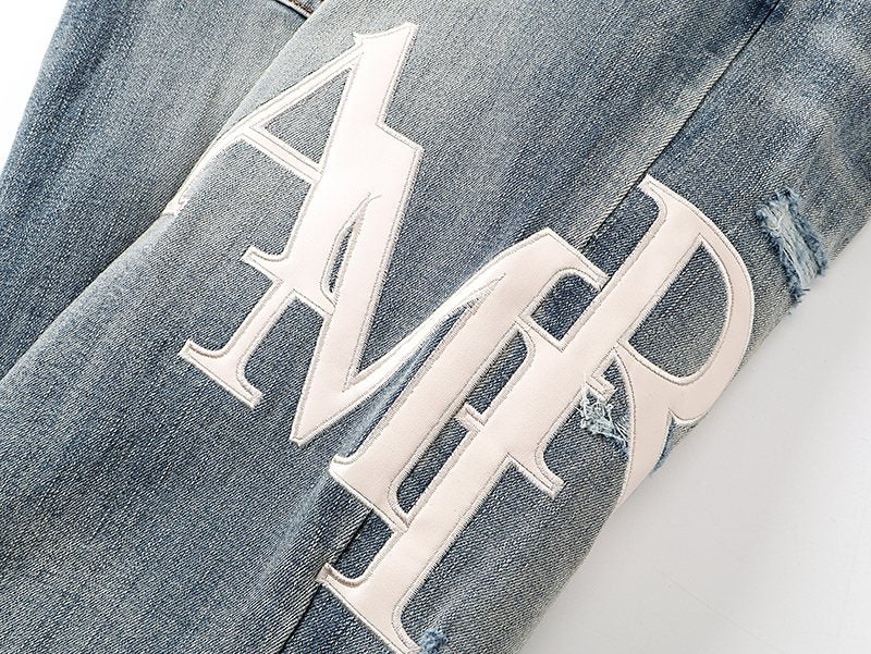 AMIRI Light Blue Distressed Letter Graphic Jeans — detail