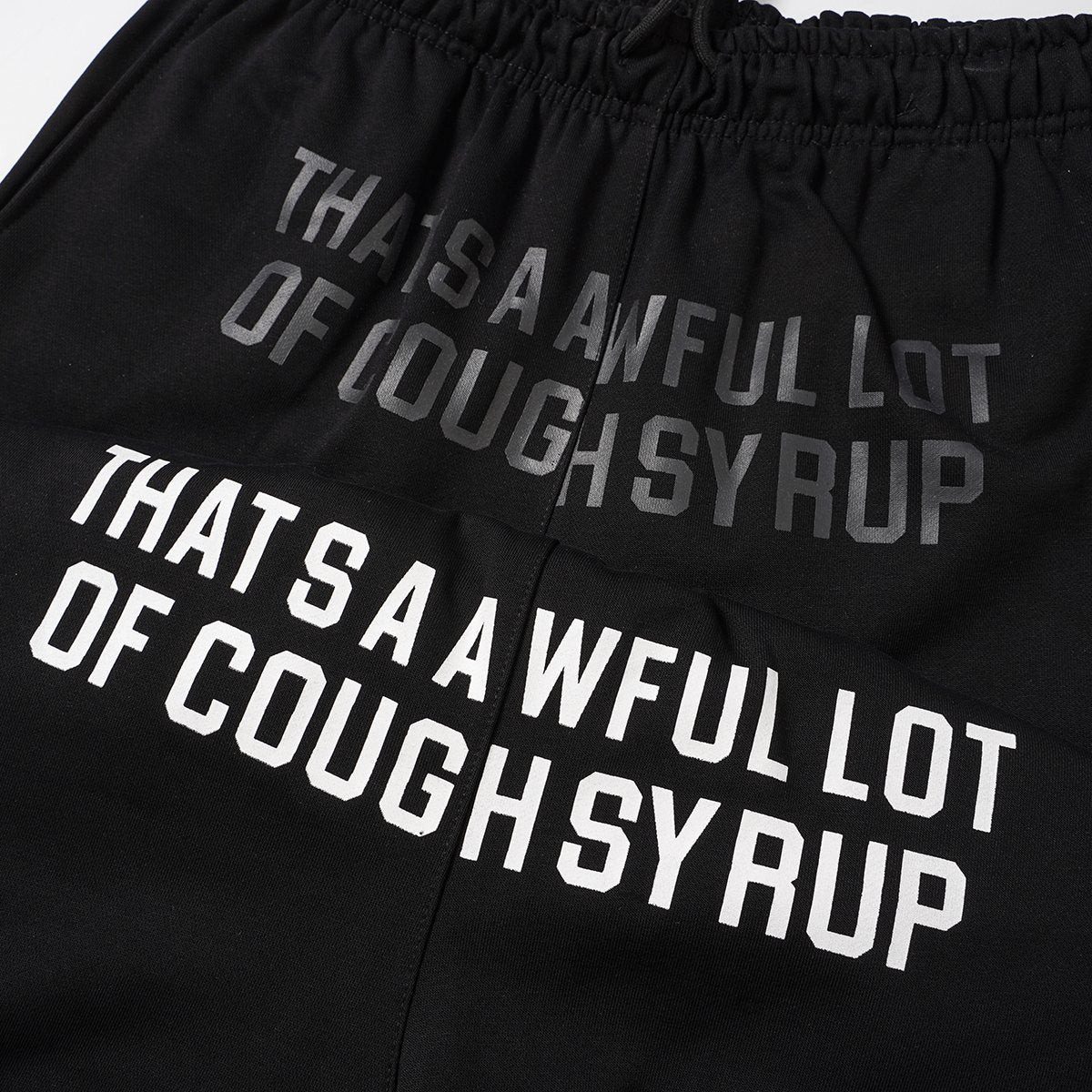 THAT'S A AWFUL LOT OF COUGH SYRUP Black Graphic Shorts — detail
