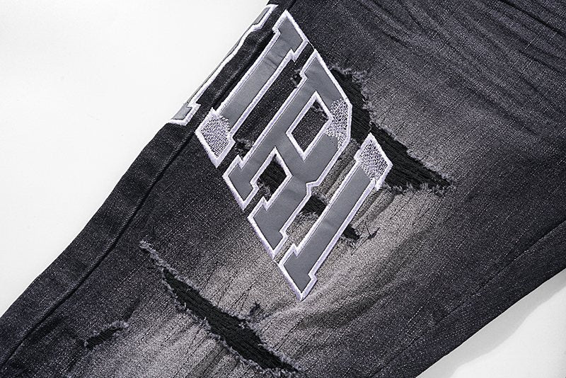AMIRI Distressed Washed Black Graphic Jeans — detail