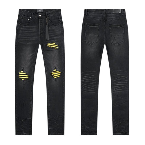AMIRI Yellow-Backed Distressed Black Jeans — hero
