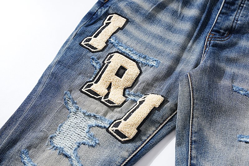 Amiri Varsity Letter Patch Distressed Jeans — detail