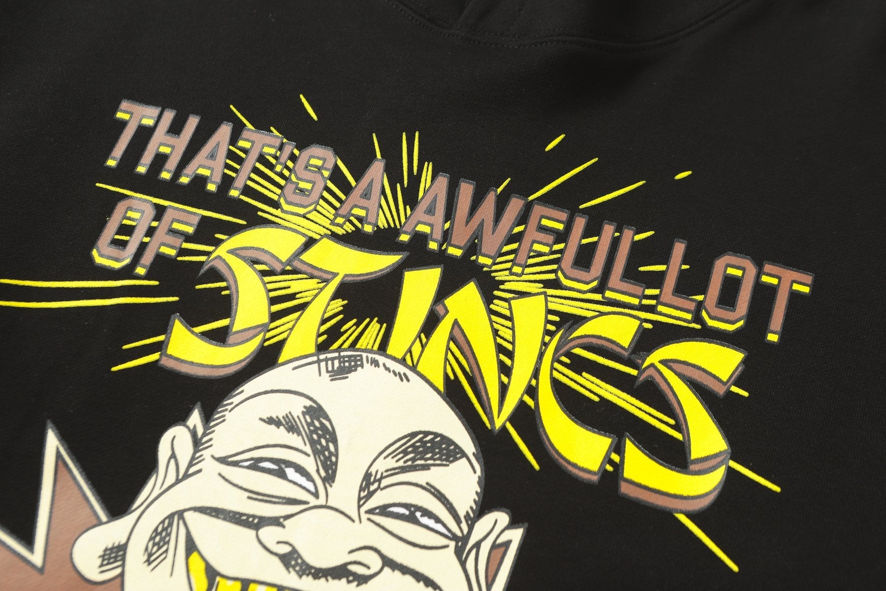 THAT'S A AWFUL LOT OF COUGH SYRUP Stings Character Graphic Hoodie — detail