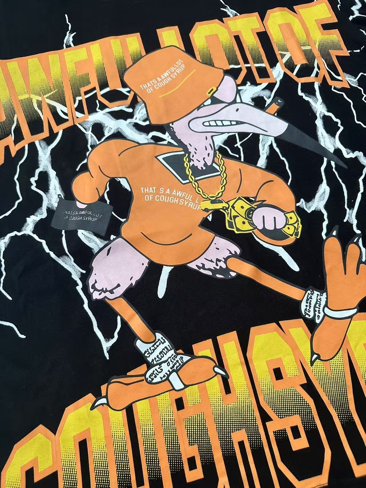 THAT'S A AWFUL LOT OF COUGH SYRUP Lightning Cartoon Graphic T-Shirt — detail